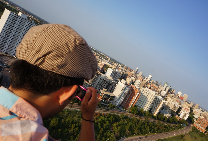 Picture of someone taking a picture of their view from a hot air balloon